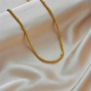 Elegant and niche design, hollowed out cylindrical chain, gold bead tassel pendant, titanium steel jewelry necklace